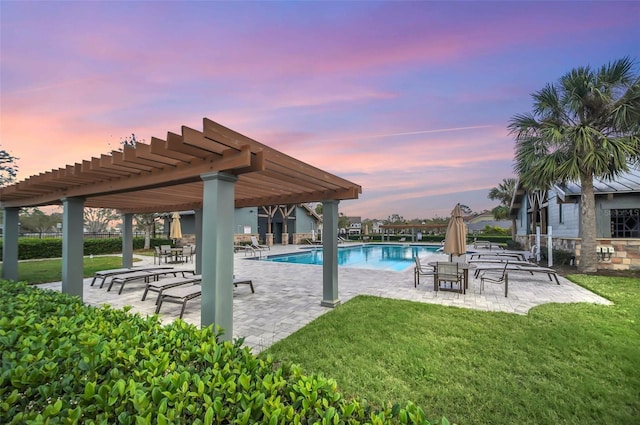 pool with a lawn, a patio, and a pergola