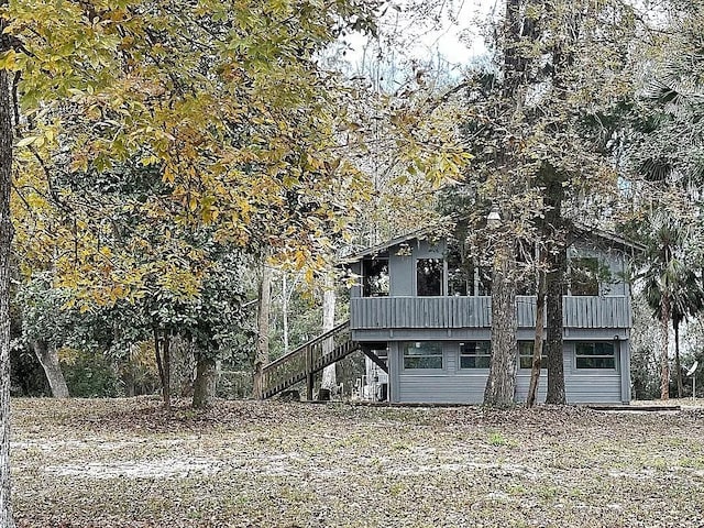 rear view of property with stairway