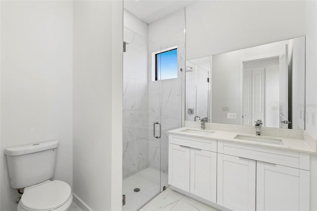 bathroom featuring marble finish floor, a marble finish shower, a sink, and toilet