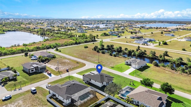 birds eye view of property featuring a residential view and a water view