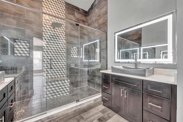 bathroom featuring a stall shower, vanity, and wood finished floors