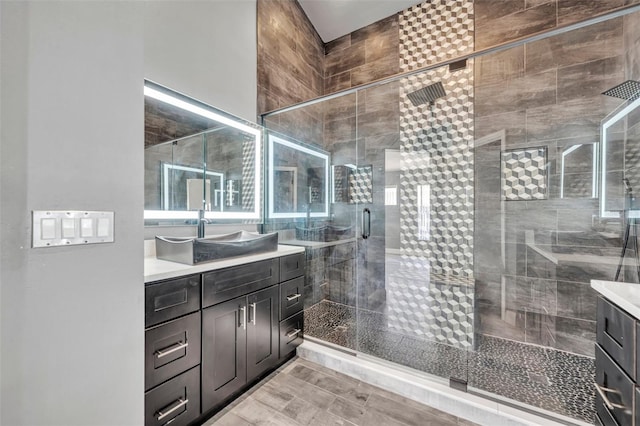 bathroom featuring a shower stall and vanity