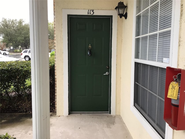 property entrance featuring stucco siding