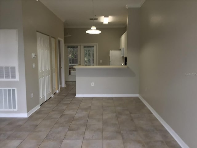 interior space with light tile patterned floors, visible vents, and baseboards