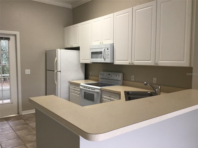 kitchen featuring light countertops, ornamental molding, a sink, tile patterned flooring, and white appliances