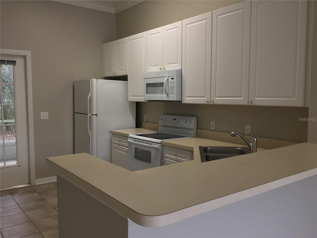 kitchen with white appliances, light countertops, crown molding, a sink, and light tile patterned flooring