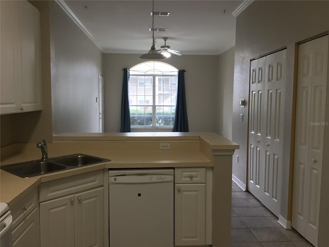 kitchen featuring white dishwasher, a peninsula, a sink, light countertops, and crown molding