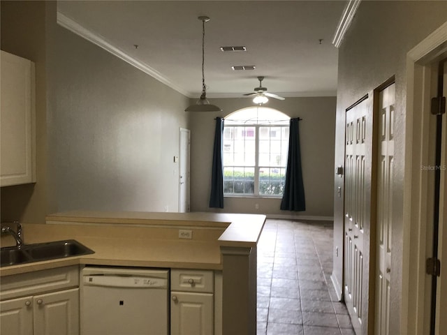 kitchen with crown molding, visible vents, white dishwasher, a sink, and a peninsula