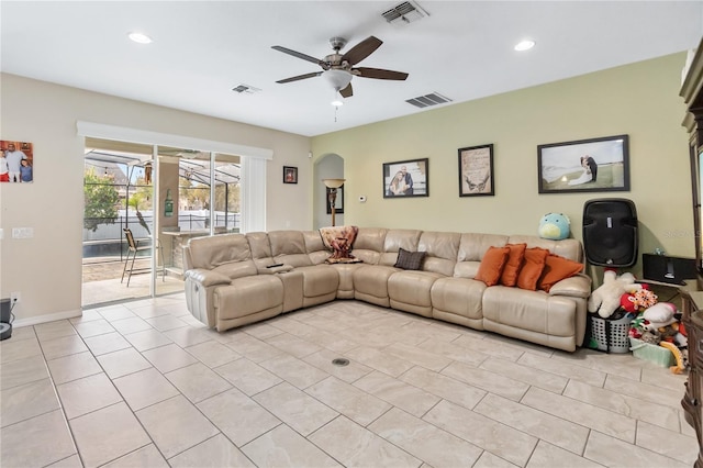 living area featuring a ceiling fan, visible vents, and light tile patterned floors