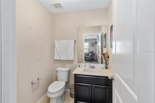 bathroom with toilet, baseboards, visible vents, and vanity