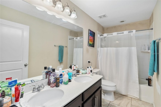 full bath featuring visible vents, a sink, toilet, and double vanity