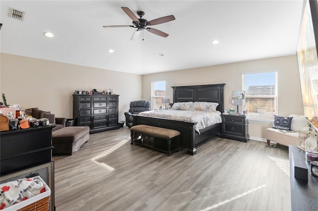 bedroom featuring light wood-style floors, multiple windows, visible vents, and recessed lighting