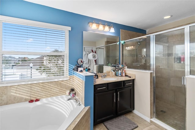 bathroom with a stall shower, tile patterned flooring, a bath, and vanity