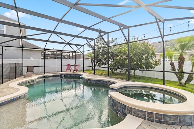 view of pool with glass enclosure, a pool with connected hot tub, a fenced backyard, and a patio