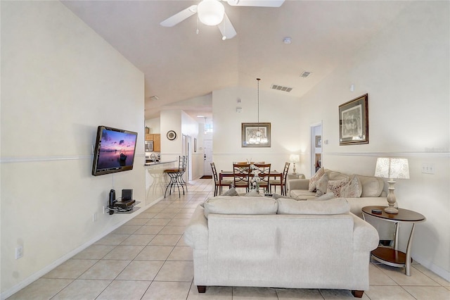 living area with ceiling fan, visible vents, vaulted ceiling, and light tile patterned floors