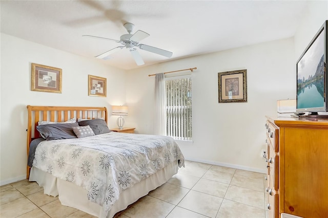 bedroom featuring a ceiling fan, light tile patterned flooring, and baseboards