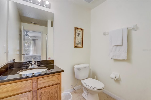 bathroom featuring toilet, visible vents, baseboards, vanity, and tile patterned floors