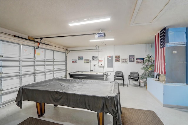 recreation room with a garage, electric panel, concrete flooring, and concrete block wall