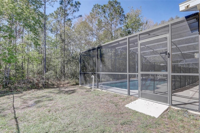 view of yard with a lanai and an outdoor pool