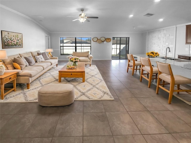 tiled living area featuring visible vents, ceiling fan, crown molding, a sink, and recessed lighting