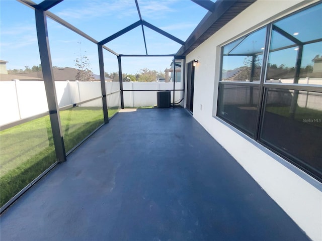 view of patio with glass enclosure, a fenced backyard, and central AC