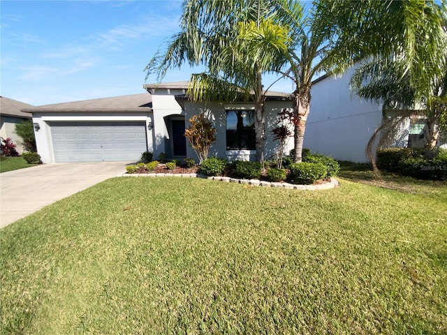 view of front of home featuring a garage, driveway, a front lawn, and stucco siding