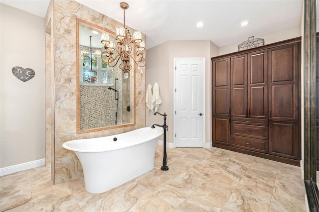 full bathroom with a chandelier, a freestanding bath, baseboards, and walk in shower