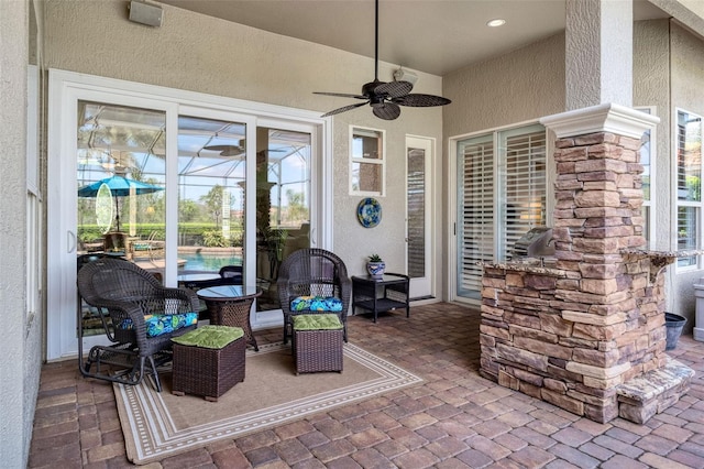 view of patio / terrace featuring a lanai and a ceiling fan