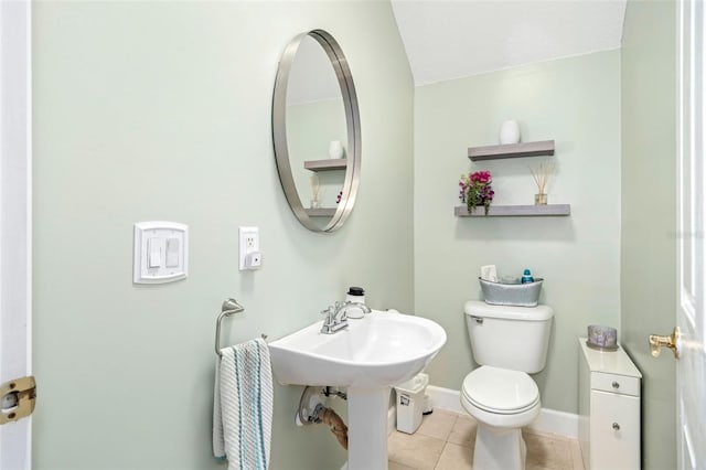 bathroom featuring toilet, tile patterned flooring, and baseboards