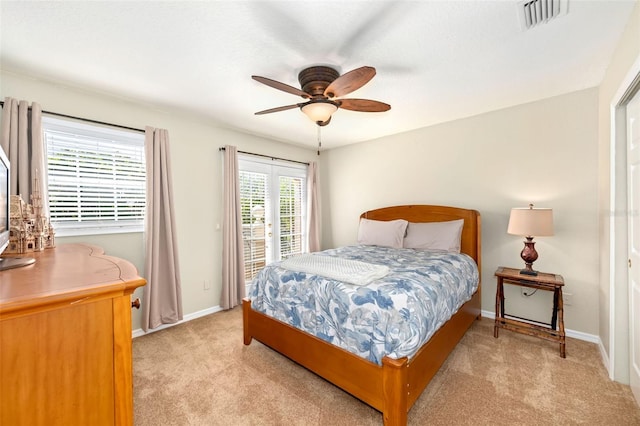 bedroom featuring light carpet, visible vents, baseboards, a ceiling fan, and access to outside