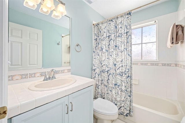 bathroom featuring shower / tub combo with curtain, vanity, and toilet