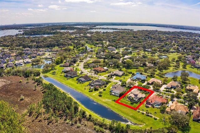 birds eye view of property with a water view and a residential view