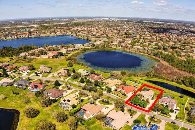 birds eye view of property with a water view and a residential view