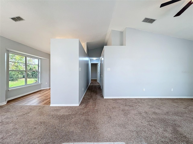 spare room featuring carpet floors, visible vents, ceiling fan, and baseboards