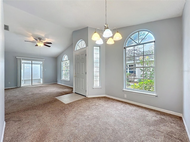 foyer entrance featuring lofted ceiling, baseboards, visible vents, and light colored carpet