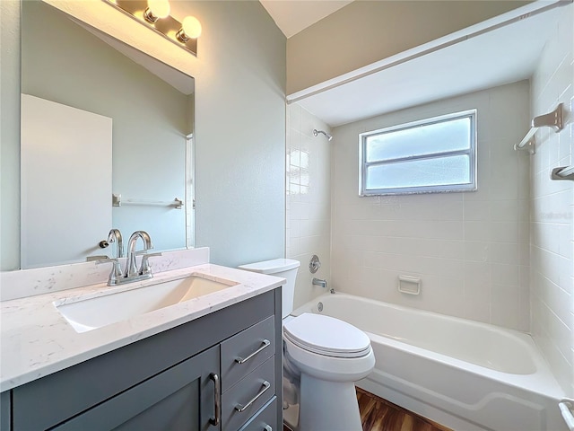 full bathroom featuring shower / bath combination, vanity, toilet, and wood finished floors