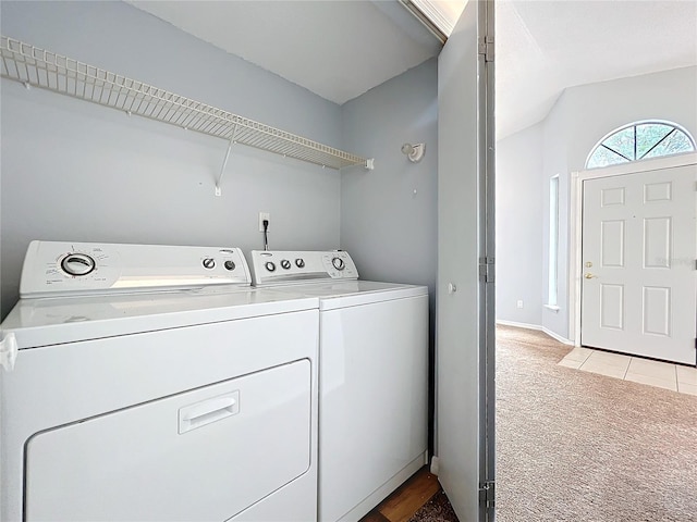 clothes washing area with laundry area, baseboards, light colored carpet, and independent washer and dryer