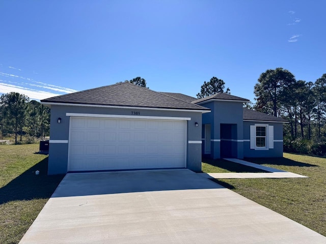 single story home with a garage, concrete driveway, a front lawn, and stucco siding