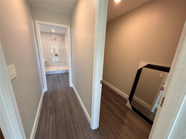 hall with dark wood finished floors and baseboards