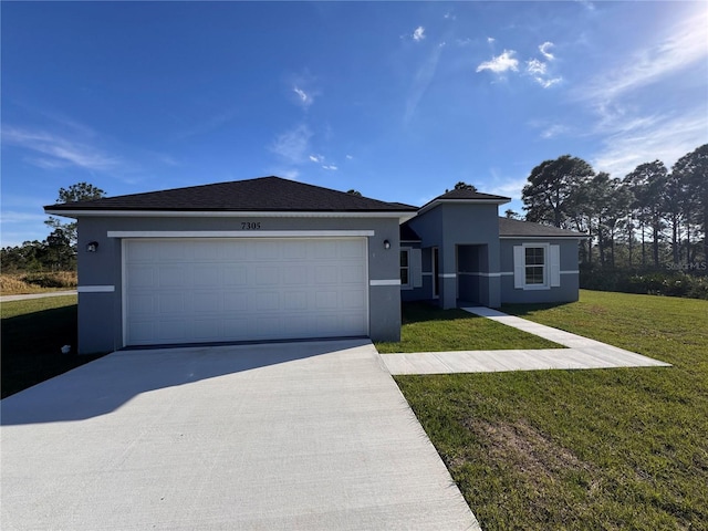 view of front of property featuring a garage, a front yard, concrete driveway, and stucco siding