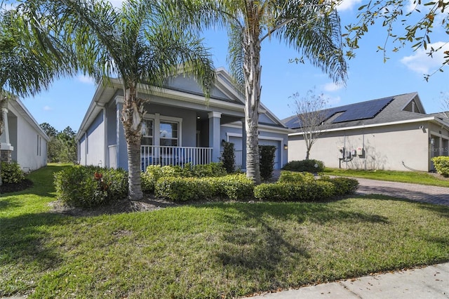 view of front facade with a garage, covered porch, decorative driveway, stucco siding, and a front yard