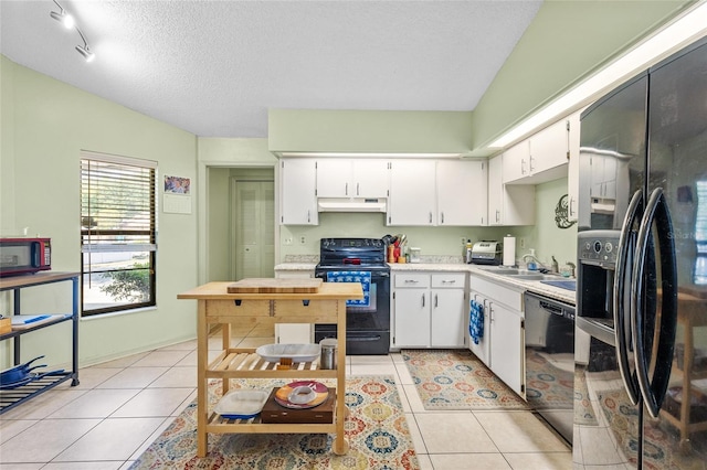 kitchen featuring under cabinet range hood, light countertops, black appliances, a sink, and white cabinetry