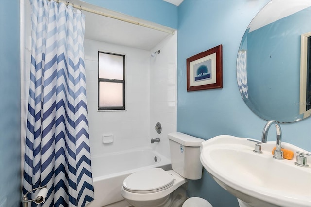 full bath featuring toilet, a sink, and shower / tub combo with curtain