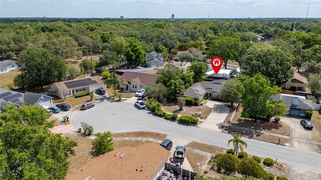aerial view featuring a wooded view and a residential view