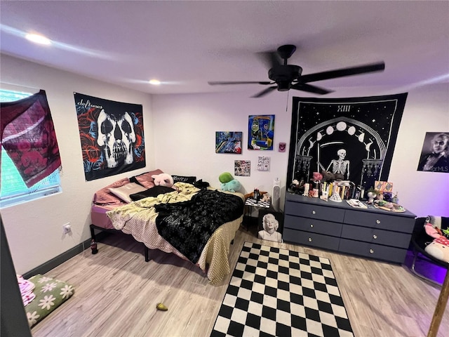 bedroom with baseboards, a ceiling fan, and wood finished floors