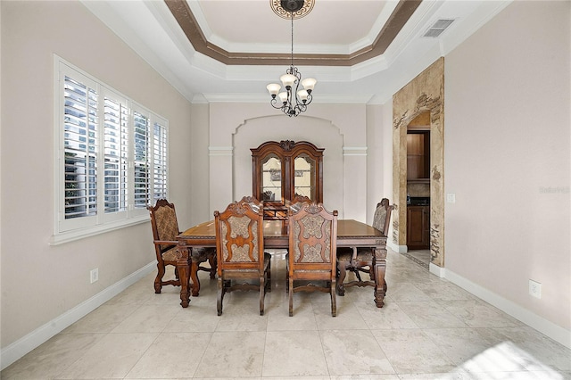 dining room with a chandelier, visible vents, baseboards, ornamental molding, and a raised ceiling