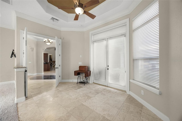 spare room featuring arched walkways, ornamental molding, a raised ceiling, and visible vents