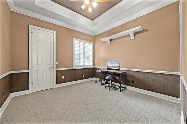 carpeted office featuring a tray ceiling, crown molding, and baseboards