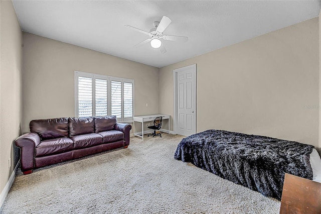 carpeted bedroom with a ceiling fan and baseboards