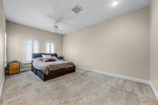 bedroom featuring carpet floors, visible vents, and baseboards